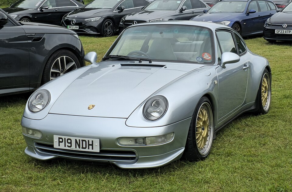 Silver Porsche 993 Carrera 4 coupe with gold wheels