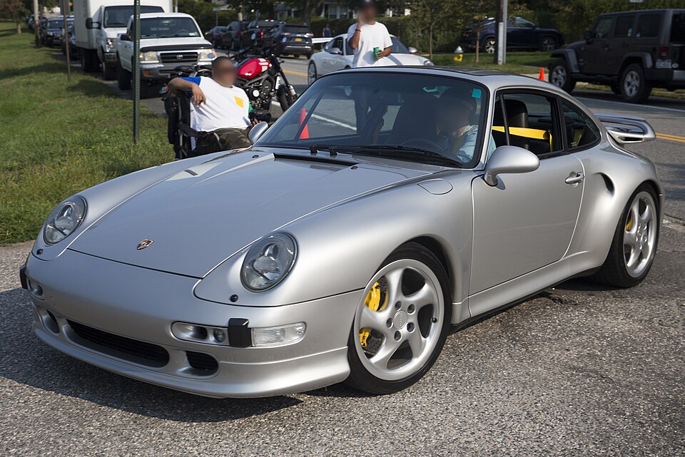 Silver Porsche 993 Turbo S showing its rear-quarter intake and yellow brake calipers