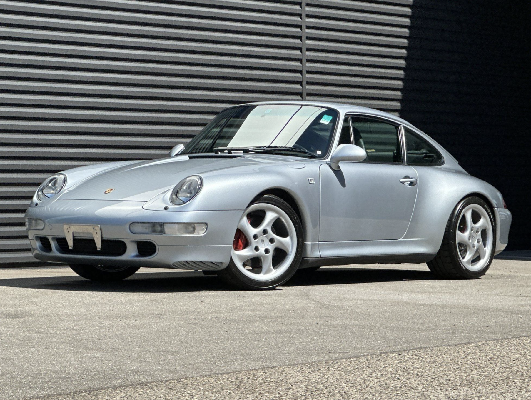 Silver Porsche 993 Carrera 4S photographed from a front three-quarter angle